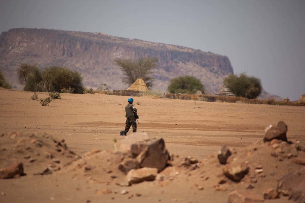 A UN peacekeeper stands guard as regional and community leaders meet for talks in Darfur. (file photo)